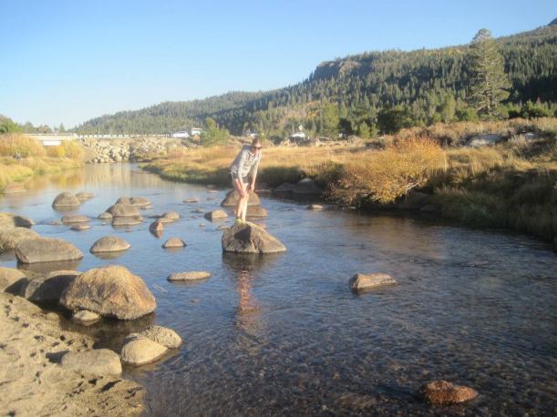 Rock hopping on the Carson River during the fall in Hope Valley, California.